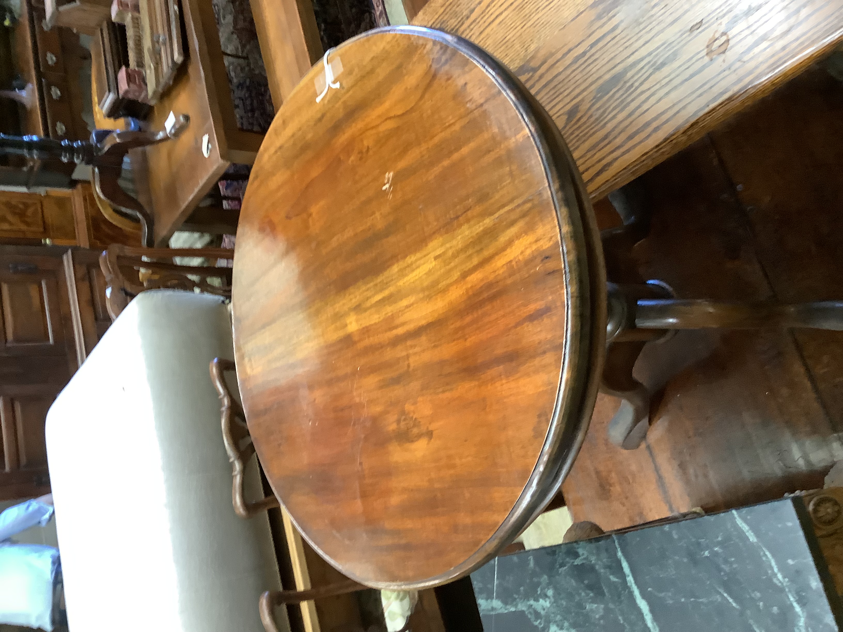 A circular mahogany occasional table on tripod base, diameter 60cm, height 70cm together with a rectangular oak low occasional table, width 106cm, height 42cm